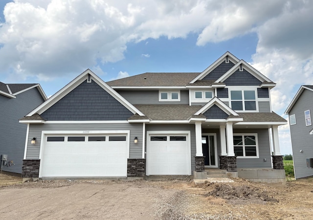 11350 84th St NE, Otsego, MN 55330 - craftsman house featuring dirt driveway, stone siding, an attached garage, and a shingled roof