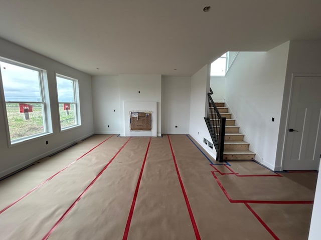 11350 84th St NE, Otsego, MN 55330 - unfurnished living room featuring stairway and baseboards