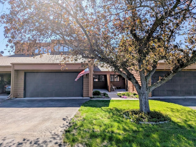 38546 Grand Ave, North Branch, MN 55056 - view of property hidden behind natural elements featuring a garage, asphalt driveway, and a front yard