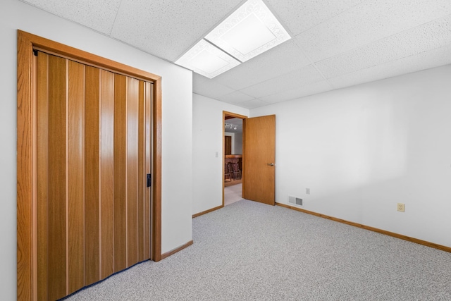 38546 Grand Ave, North Branch, MN 55056 - unfurnished bedroom with a drop ceiling, baseboards, light colored carpet, and a closet