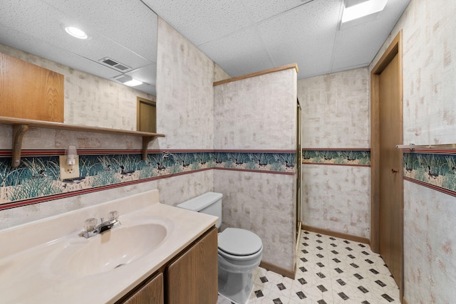 38546 Grand Ave, North Branch, MN 55056 - full bathroom featuring a paneled ceiling, tile patterned floors, a tile shower, toilet, and vanity
