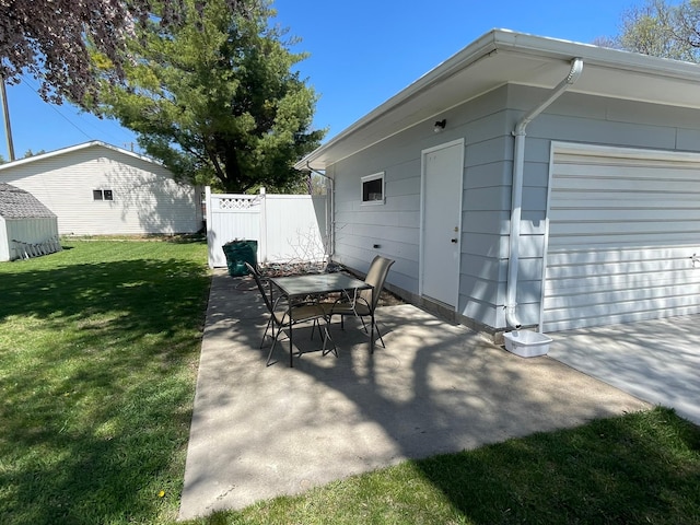 112 Walnut St, Dawson, MN 56232 - view of patio with an outbuilding, a garage, and outdoor dining space