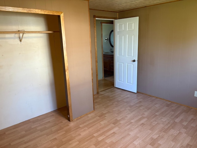 307 Deerwood Ln S, Onamia, MN 56359 - unfurnished bedroom featuring light wood-type flooring, a sink, and wood walls