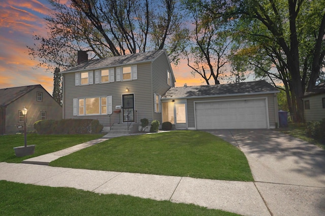 view of front of property with a chimney, driveway, a lawn, and a garage