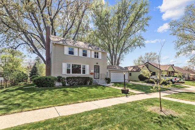 view of front of property with a chimney, a front yard, driveway, and a garage
