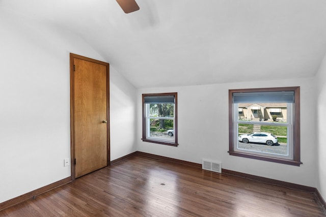 bonus room with lofted ceiling, ceiling fan, wood finished floors, and baseboards