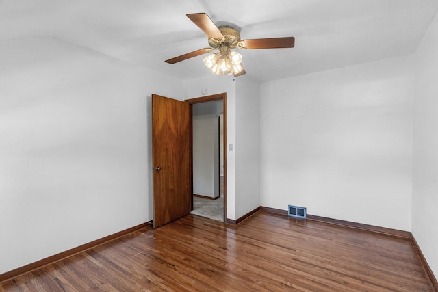 spare room featuring wood finished floors, ceiling fan, and baseboards