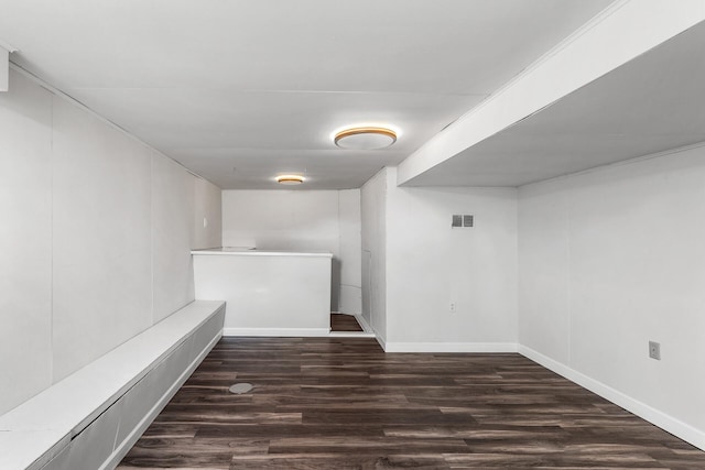 finished below grade area with wood finished floors and baseboards