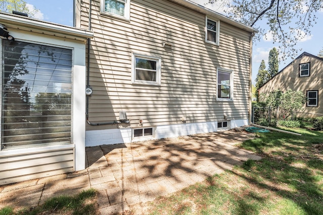 view of side of property with a patio area