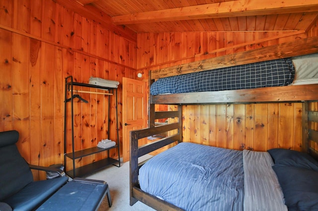 carpeted bedroom featuring wooden walls and wooden ceiling