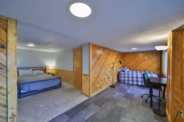 bedroom featuring wood walls and baseboards