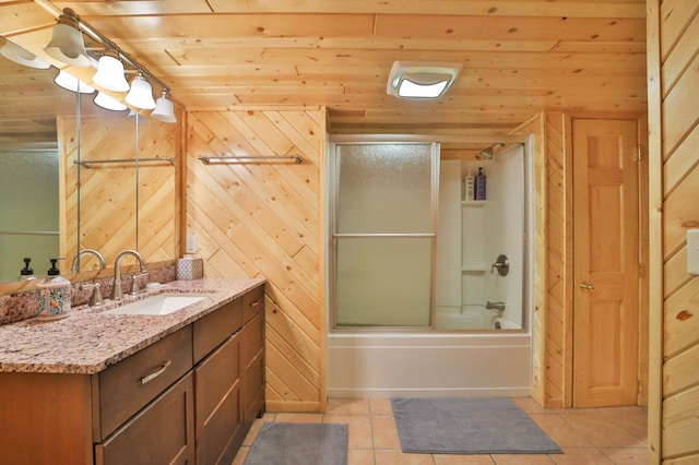 bathroom with tile patterned floors, vanity, shower / bath combination with glass door, wooden ceiling, and wood walls