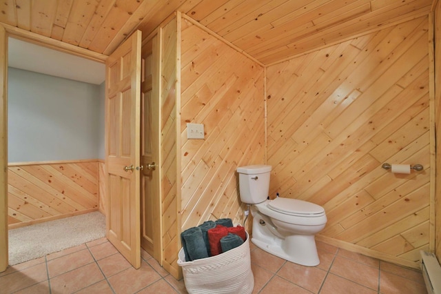 bathroom featuring wood walls, toilet, tile patterned floors, wooden ceiling, and baseboard heating