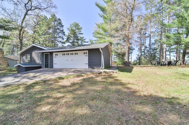 view of side of property featuring a lawn and an attached garage