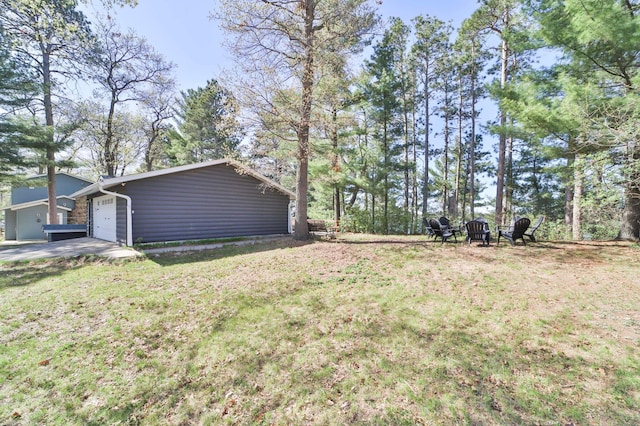 view of green lawn with a garage