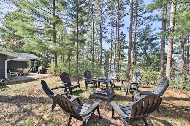 view of yard featuring an outdoor fire pit and a patio area