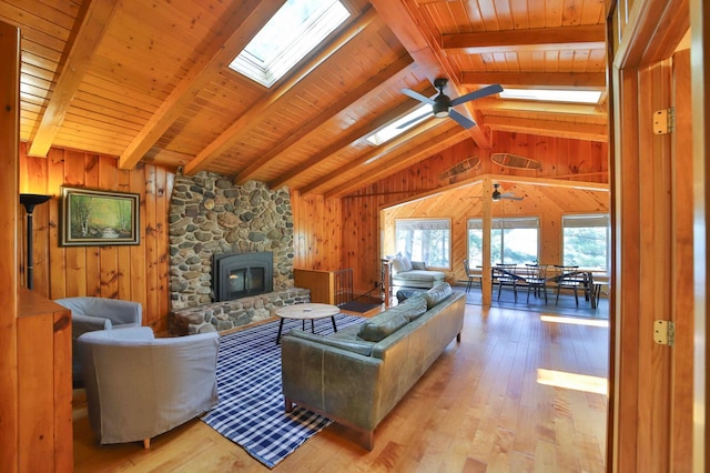 2202 Pine View Blvd, Motley, MN 56466 - living room with ceiling fan, wood walls, a skylight, a fireplace, and wood-type flooring