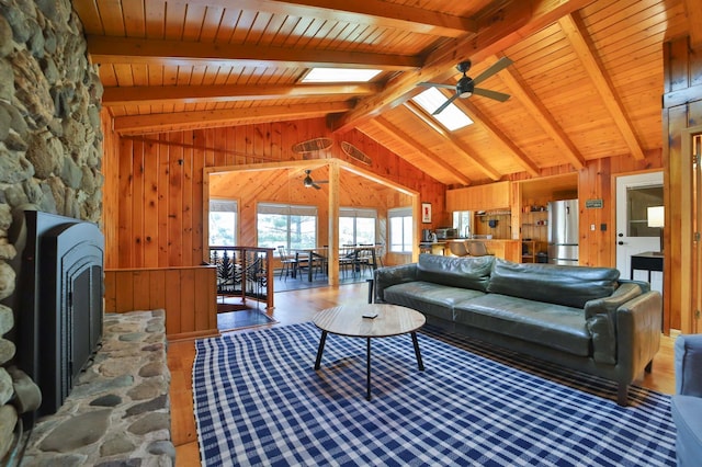 2202 Pine View Blvd, Motley, MN 56466 - living room with a ceiling fan, a skylight, wood walls, wood ceiling, and wood finished floors