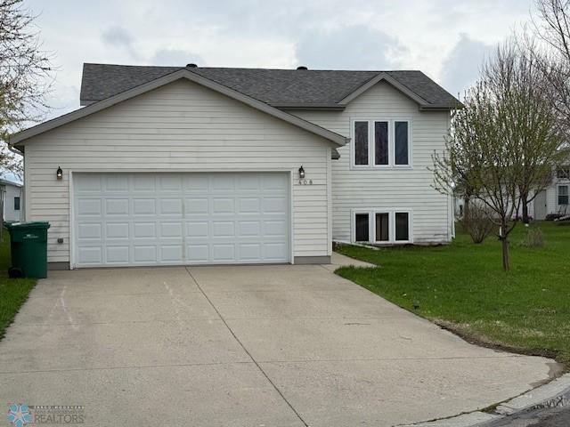 408 Np Ct, Breckenridge, MN 56520 - view of front of house featuring driveway, a front lawn, an attached garage, and roof with shingles