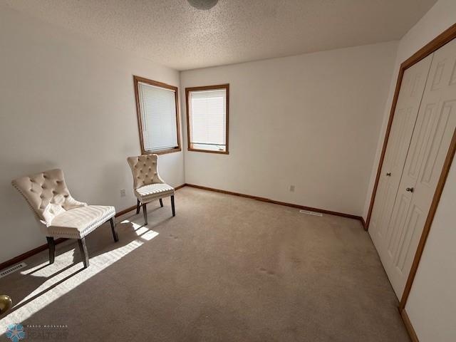 408 Np Ct, Breckenridge, MN 56520 - living area with light carpet, baseboards, and a textured ceiling