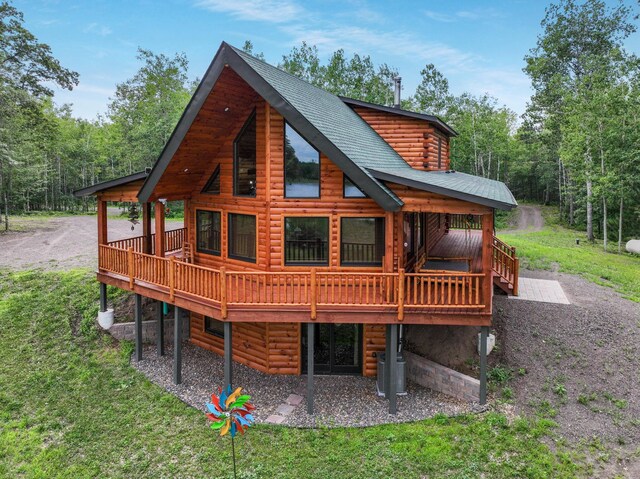 29917 Bay Dr, Danbury, WI 54830 - rear view of property featuring a deck, a yard, and a wooded view