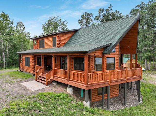 29917 Bay Dr, Danbury, WI 54830 - rear view of property featuring roof with shingles, covered porch, and log siding