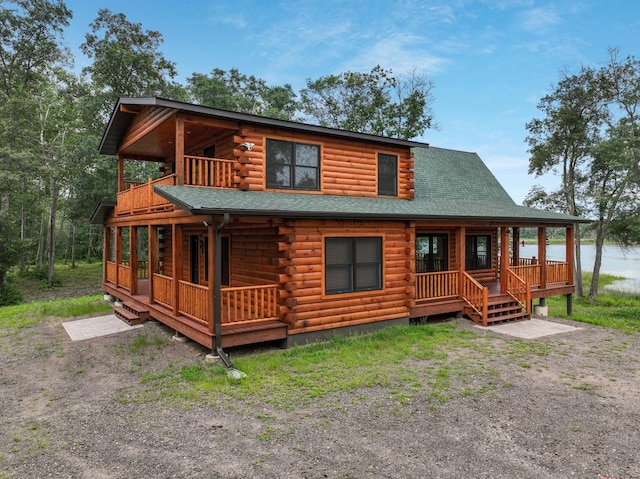 29917 Bay Dr, Danbury, WI 54830 - log cabin with covered porch, log siding, a shingled roof, and a balcony