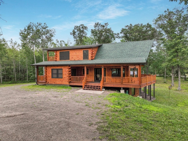 29917 Bay Dr, Danbury, WI 54830 - cabin with log siding, roof with shingles, and a front lawn