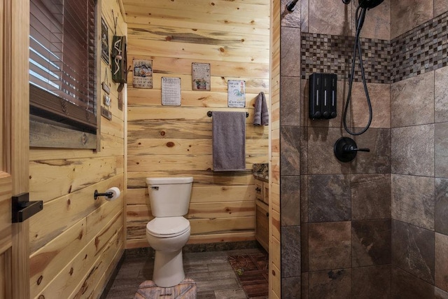 29917 Bay Dr, Danbury, WI 54830 - bathroom with toilet, tiled shower, and wood walls