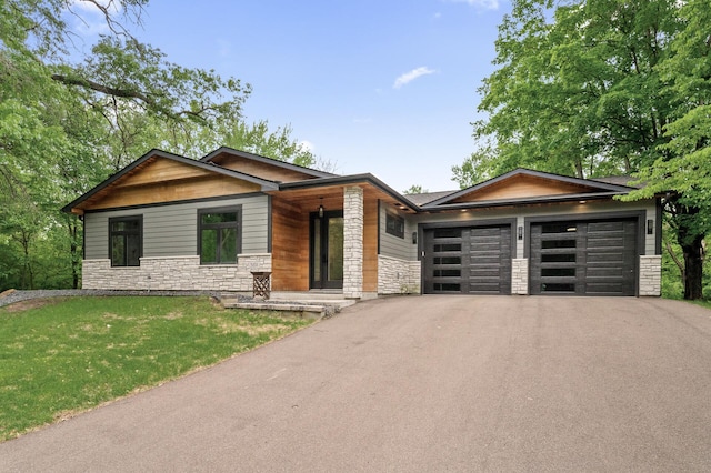 5191 159th Ave NW, Andover, MN 55304 - view of front of property featuring stone siding, asphalt driveway, an attached garage, and a front yard