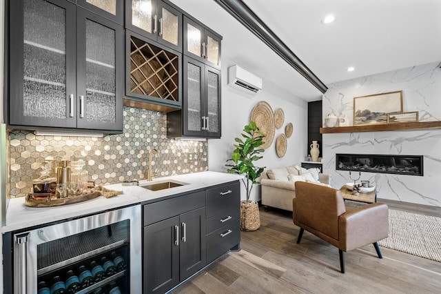 5191 159th Ave NW, Andover, MN 55304 - indoor wet bar featuring wine cooler, a wall mounted air conditioner, light wood finished floors, tasteful backsplash, and recessed lighting
