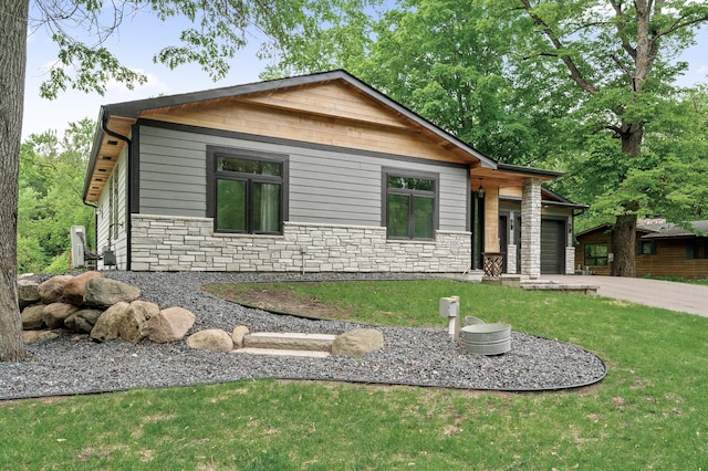 5191 159th Ave NW, Andover, MN 55304 - view of front of home with stone siding, an attached garage, a front yard, and concrete driveway