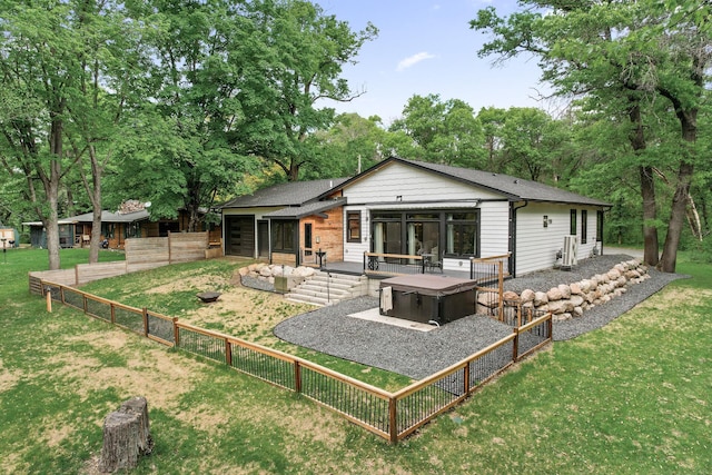 5191 159th Ave NW, Andover, MN 55304 - rear view of house featuring a hot tub, roof with shingles, and a patio area