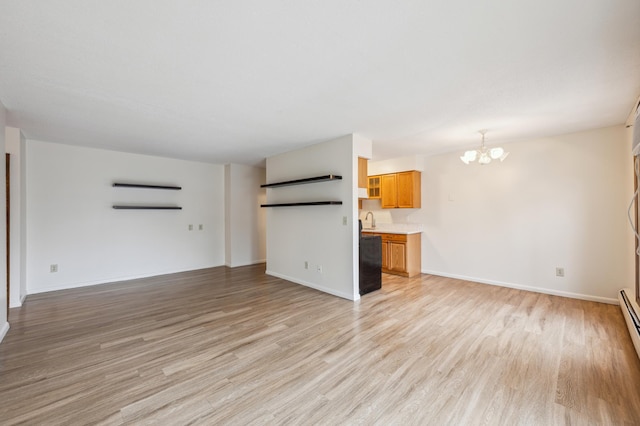 923 11th Ave S Unit 8, Hopkins, MN 55343 - unfurnished living room featuring light wood finished floors, a baseboard radiator, a notable chandelier, and baseboards
