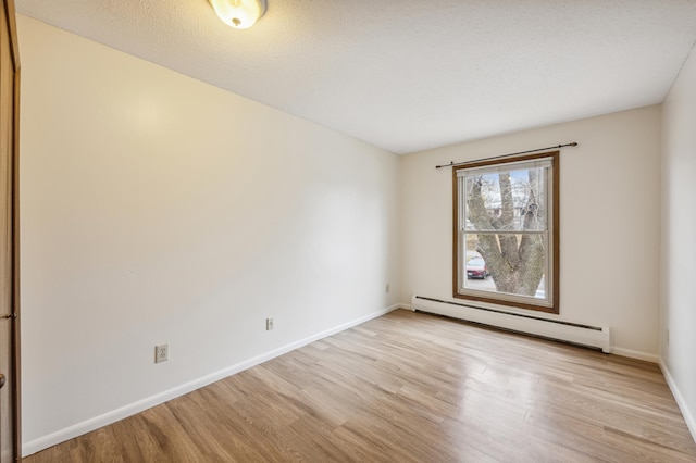 923 11th Ave S Unit 8, Hopkins, MN 55343 - empty room featuring baseboards, light wood-style floors, and baseboard heating