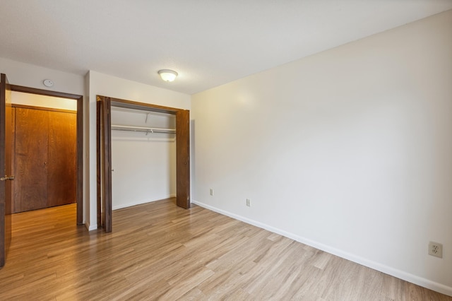 923 11th Ave S Unit 8, Hopkins, MN 55343 - unfurnished bedroom featuring baseboards, a closet, and light wood-type flooring