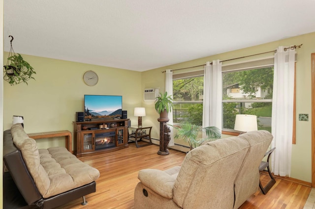 1494 21st Ave NW Unit 4, New Brighton, MN 55112 - living area featuring wood finished floors, baseboards, and an AC wall unit