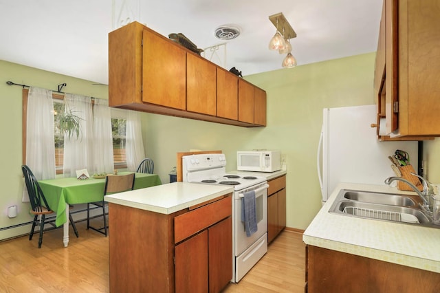 1494 21st Ave NW Unit 4, New Brighton, MN 55112 - kitchen with white appliances, a sink, light wood finished floors, light countertops, and a peninsula