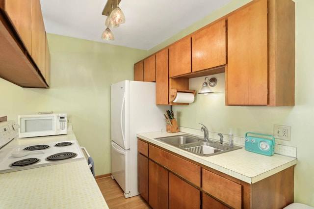 1494 21st Ave NW Unit 4, New Brighton, MN 55112 - kitchen featuring white appliances, a sink, light countertops, and light wood-type flooring