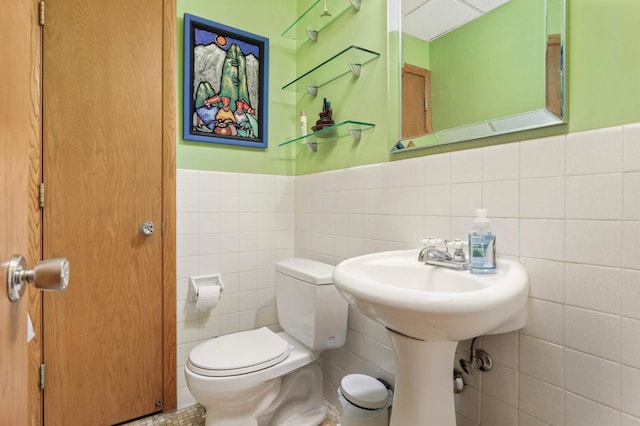 1494 21st Ave NW Unit 4, New Brighton, MN 55112 - half bathroom with tile walls, toilet, and a wainscoted wall