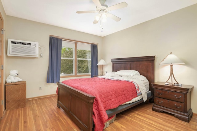 1494 21st Ave NW Unit 4, New Brighton, MN 55112 - bedroom featuring light wood finished floors, baseboards, a wall mounted AC, and a ceiling fan