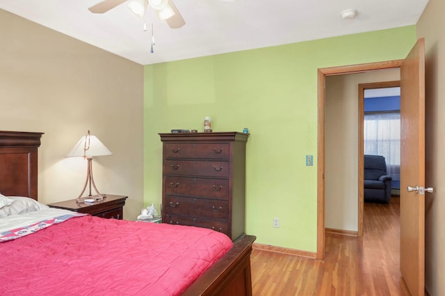 1494 21st Ave NW Unit 4, New Brighton, MN 55112 - bedroom with light wood-style floors, baseboards, and a ceiling fan