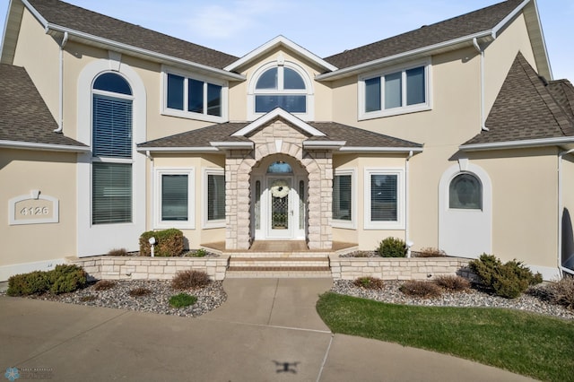 4126 Timberline Dr S, Fargo, ND 58104 - view of front of home featuring stucco siding, stone siding, and roof with shingles