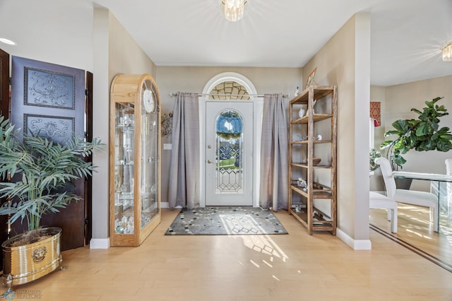 4126 Timberline Dr S, Fargo, ND 58104 - entryway featuring wood finished floors, a chandelier, and baseboards