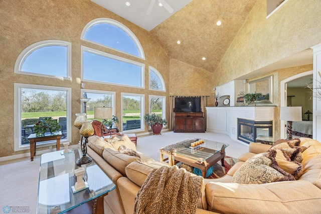 4126 Timberline Dr S, Fargo, ND 58104 - living area featuring high vaulted ceiling, healthy amount of natural light, a multi sided fireplace, recessed lighting, and a ceiling fan