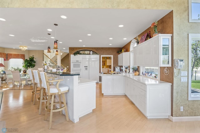 4126 Timberline Dr S, Fargo, ND 58104 - kitchen with paneled fridge, light wood-type flooring, healthy amount of natural light, and recessed lighting