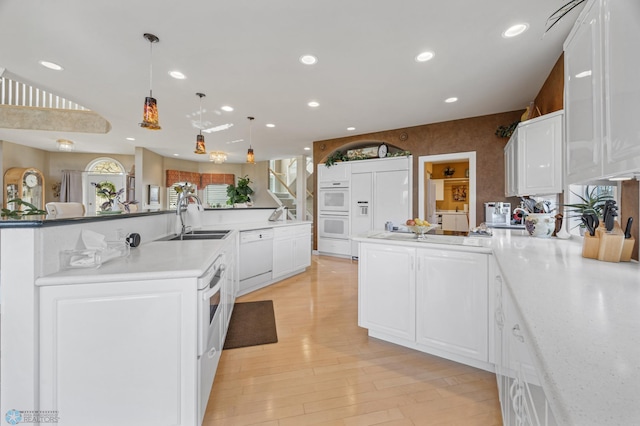 4126 Timberline Dr S, Fargo, ND 58104 - kitchen with a sink, white appliances, recessed lighting, light countertops, and white cabinets