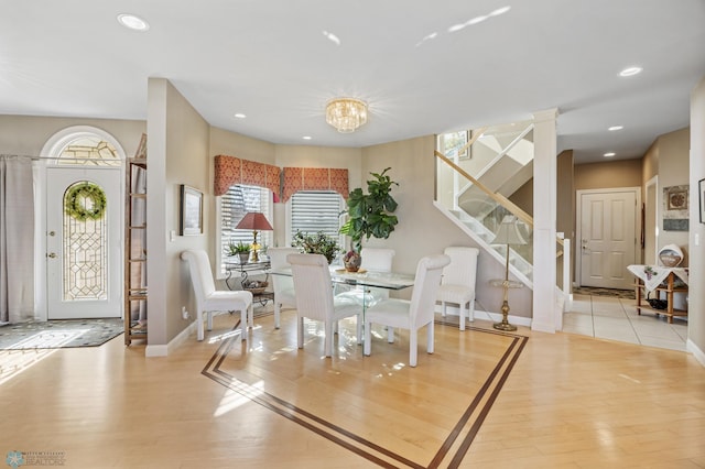 4126 Timberline Dr S, Fargo, ND 58104 - dining area featuring stairway, wood finished floors, baseboards, a chandelier, and recessed lighting