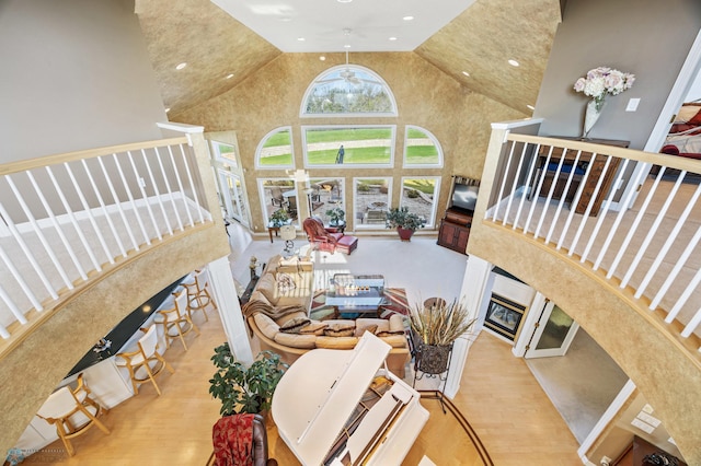 4126 Timberline Dr S, Fargo, ND 58104 - living room with a high end fireplace, wood finished floors, high vaulted ceiling, recessed lighting, and stairway