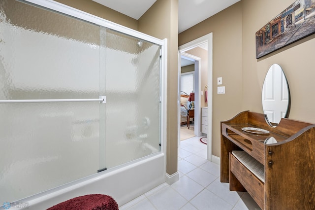 4126 Timberline Dr S, Fargo, ND 58104 - ensuite bathroom with tile patterned flooring, combined bath / shower with glass door, and baseboards